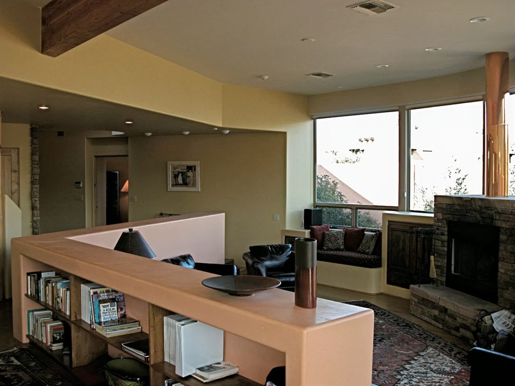Open living room with floor-to-ceiling windows showcasing views of the surrounding Sedona landscape.