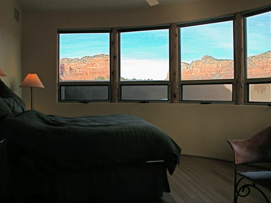 Interior living area with leather seating, accent lighting, and exposed wood beam detail.