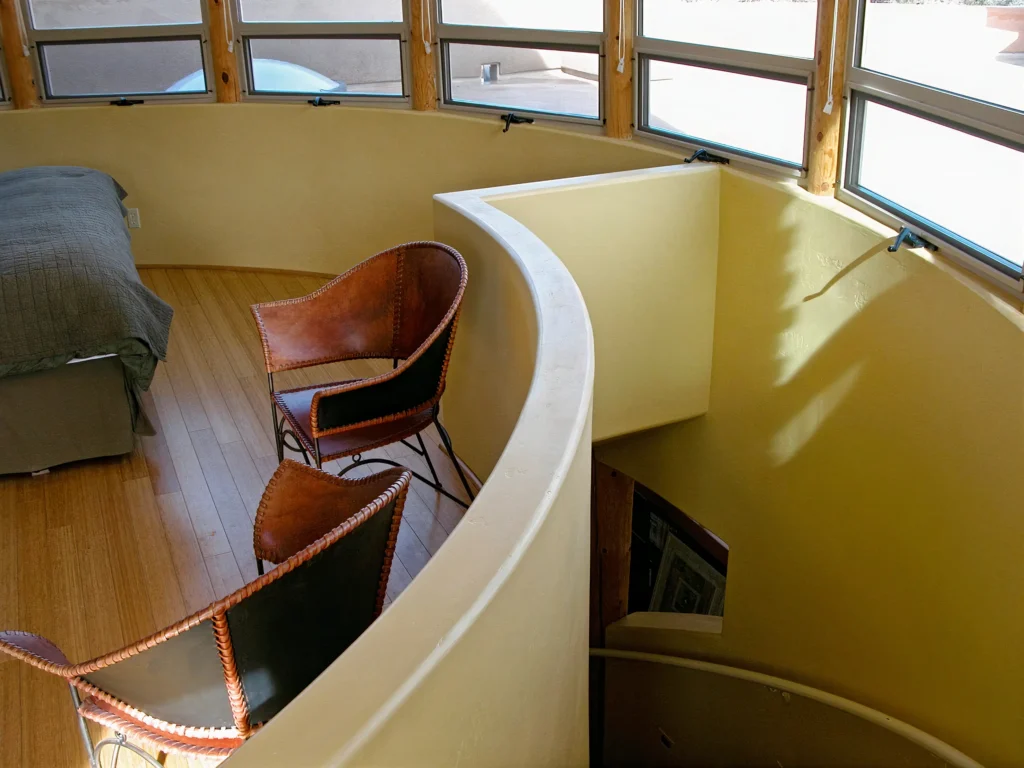 Bedroom with panoramic windows offering expansive views of Sedona’s red rock formations.