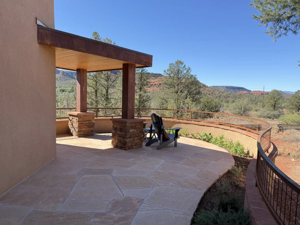 Sedona residence with shaded patio backed by beautiful forest.