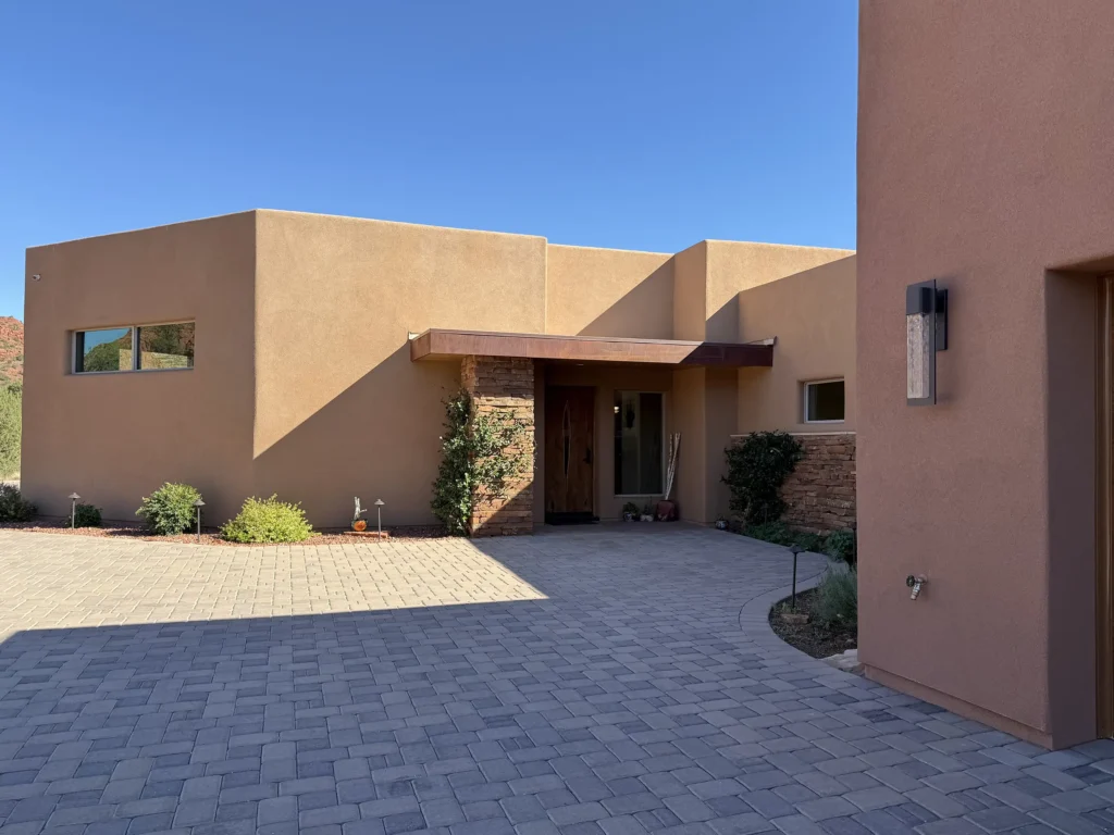 Front entry of a modern home featuring stone accents and a wood door.