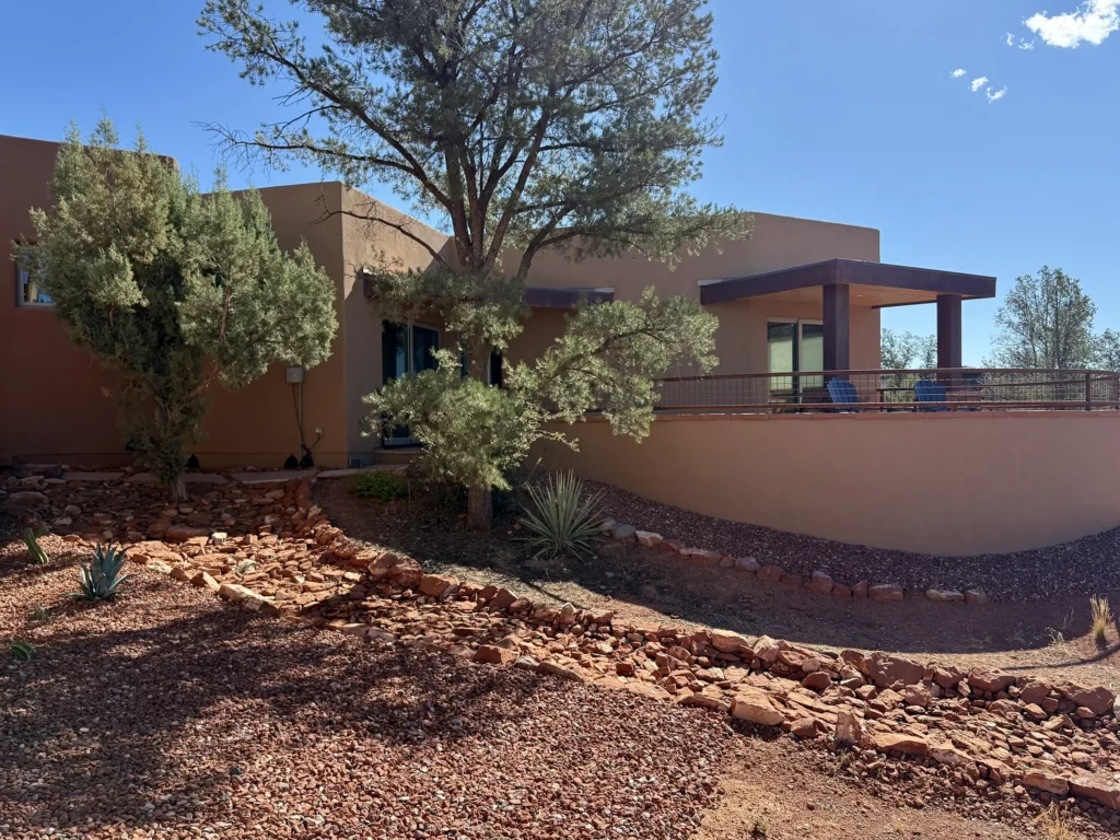 Patio of the residence surrounded by desert terrain and native vegetation.